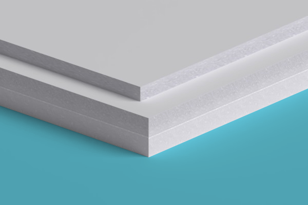 Two white sheets of paper are stacked on top of each other on a blue surface.