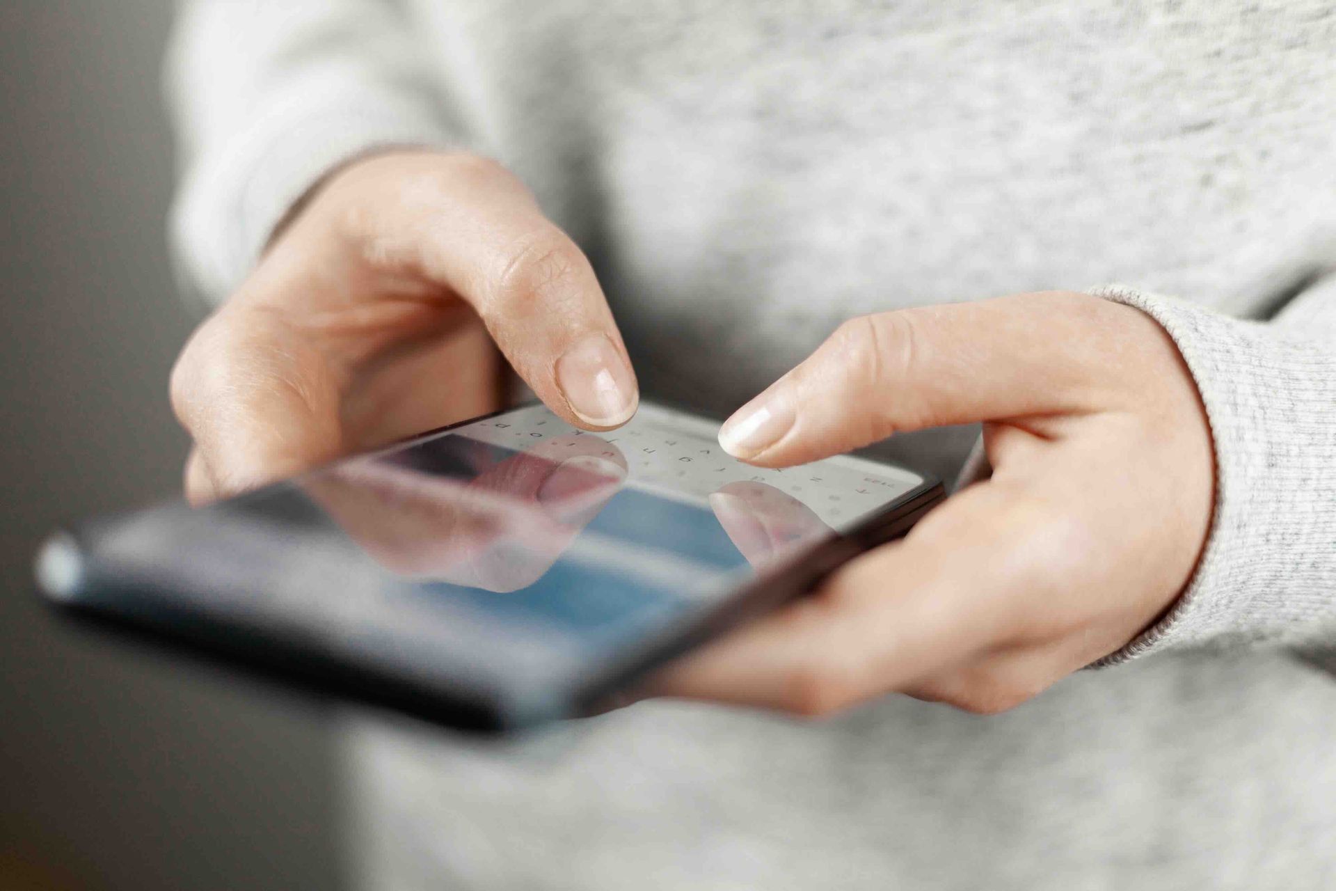 A close up of a person using a cell phone.