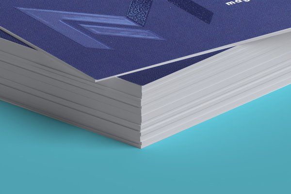 A close up of a stack of business cards on a blue surface.