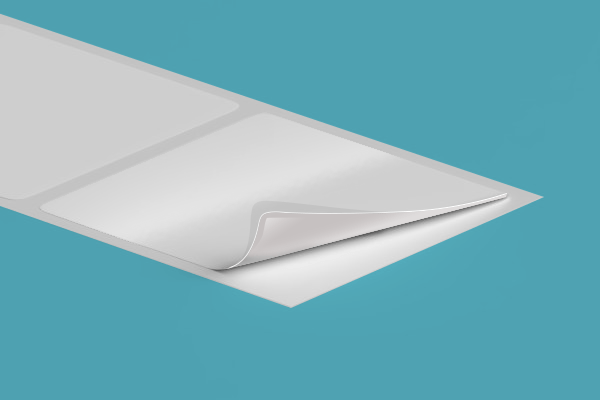 A piece of white paper is sitting on top of a blue surface.