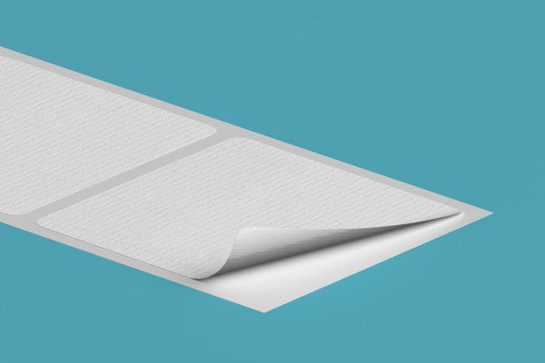 A close up of a piece of white paper on a blue background.