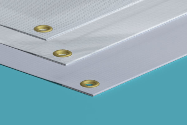 Three white sheets of paper with gold grommets are stacked on top of each other on a blue surface.