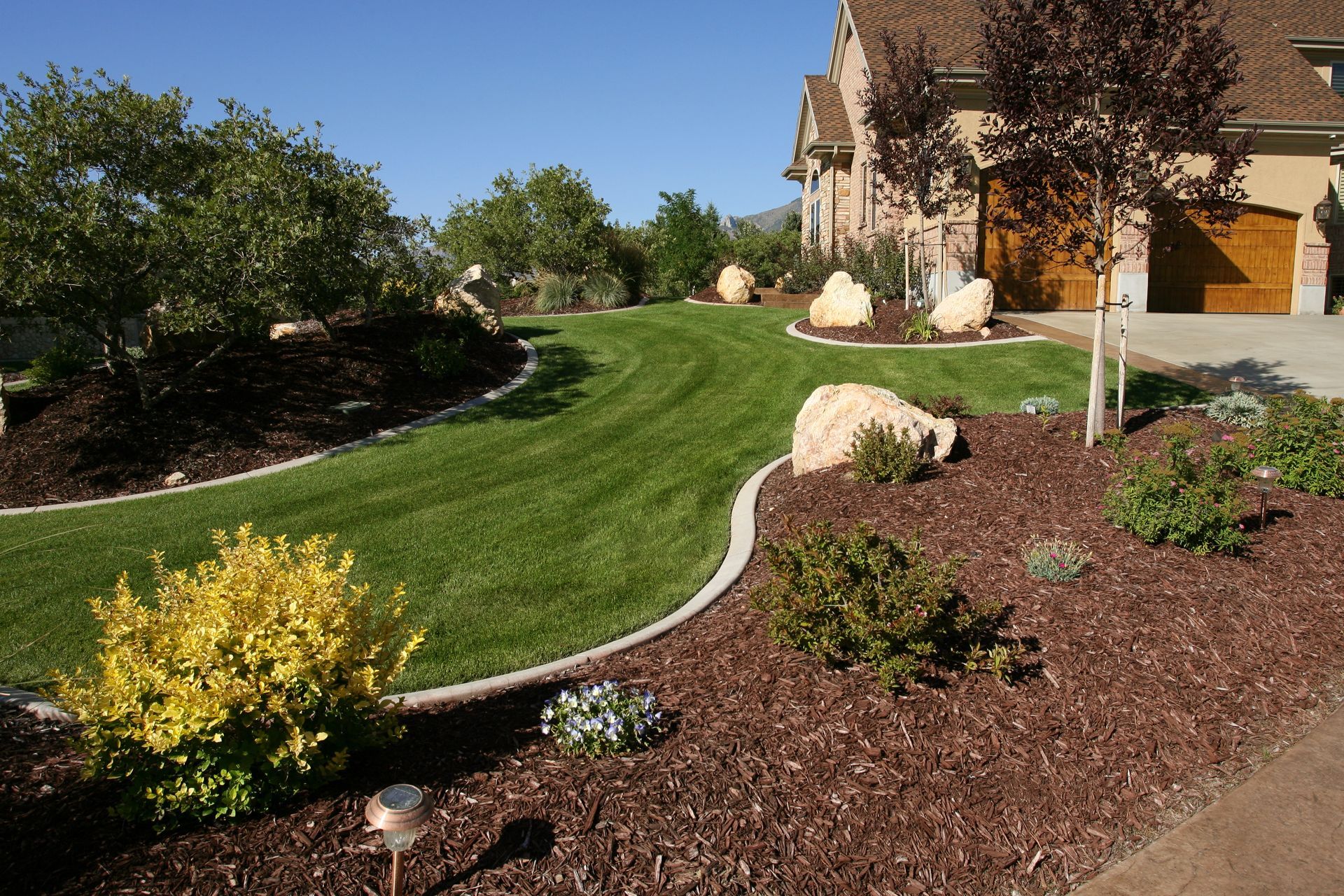 A lush green lawn in front of a house