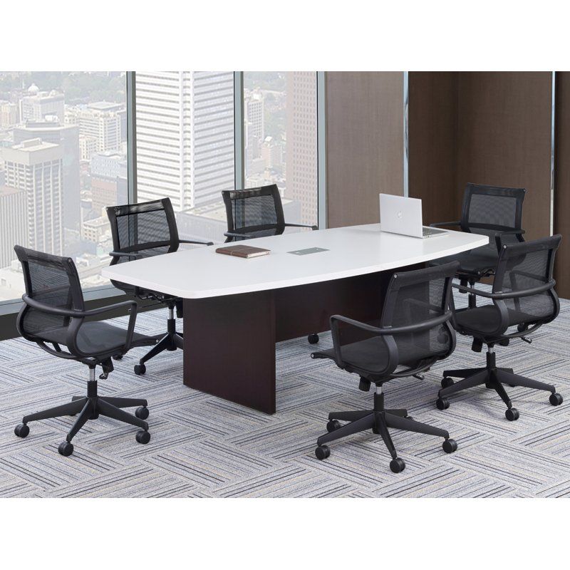 A conference room with a white table, black chairs, and a cityscape view.
