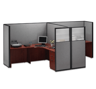 Office cubicles with gray panels and dark wood desks. One has a computer and printer.