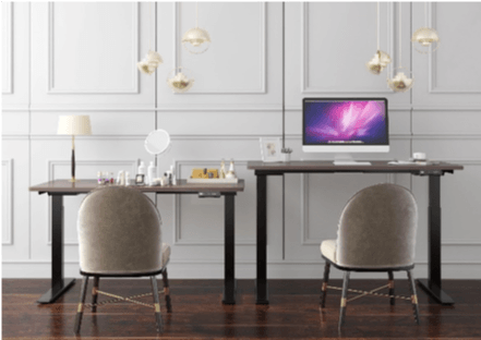 Two desks with chairs in front, with computers and makeup on the left desk. The walls are white and decorative.