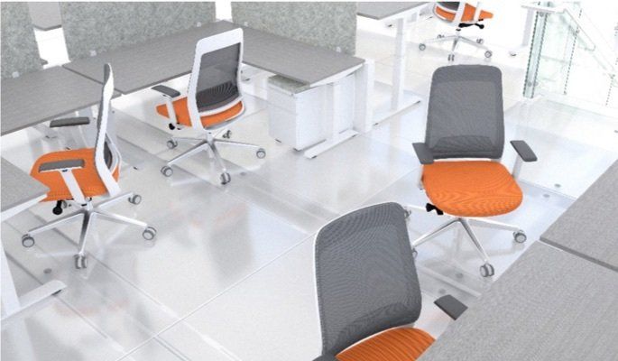 Office with gray desks and orange-seated chairs on a white floor.