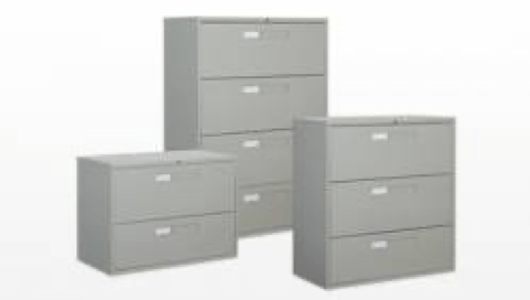 Three gray metal filing cabinets of different heights.