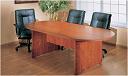 Wooden oval conference table with three black chairs.