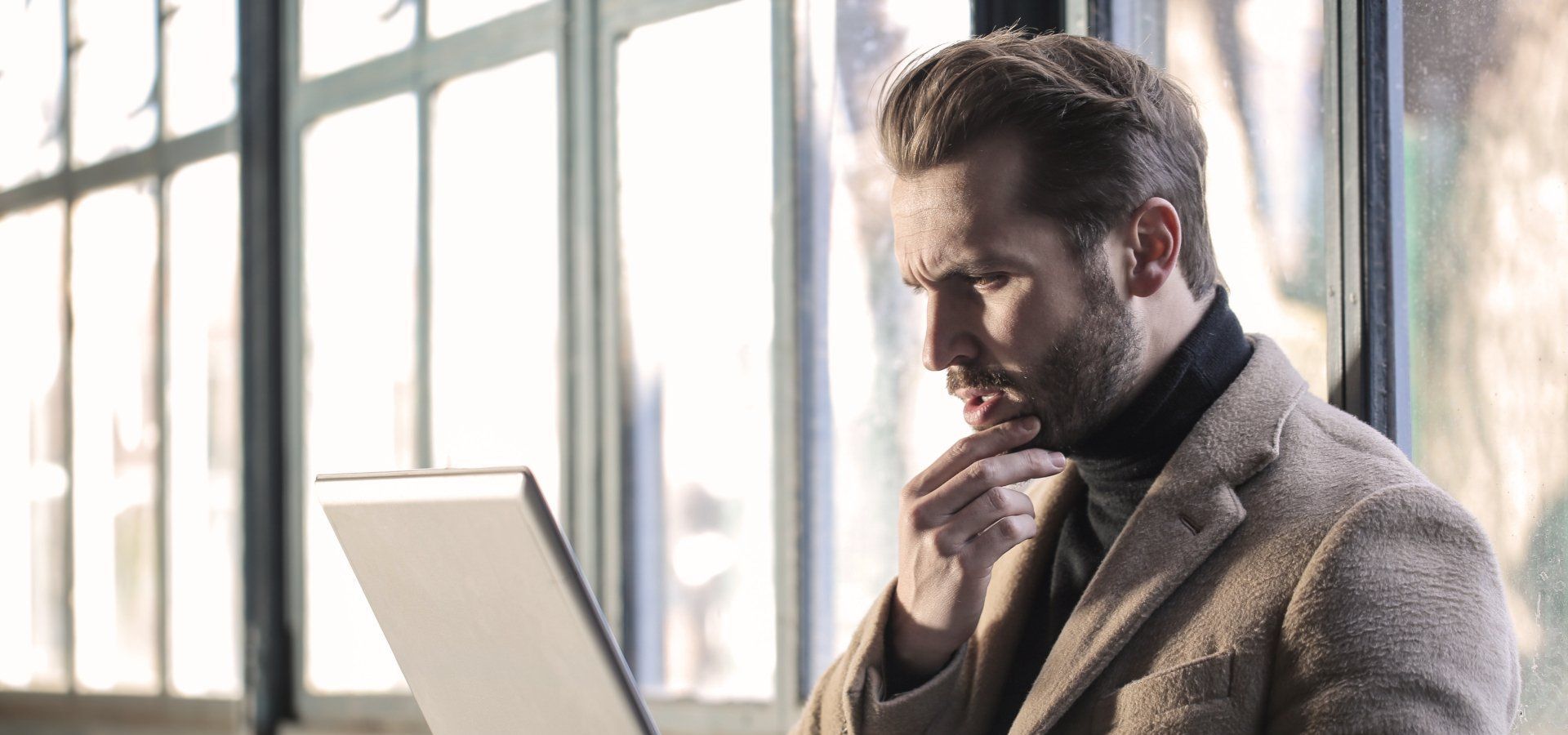 man searching internet, looking confused