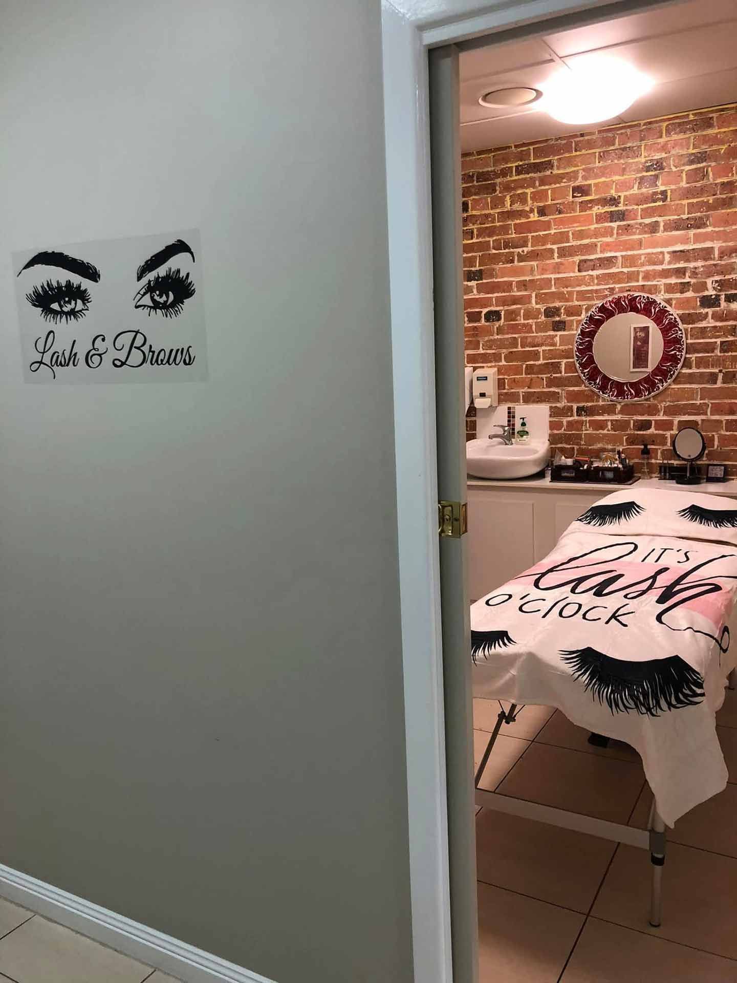 A Room With A Brick Wall And A Bed In It — Xtreme Rejuvenation Clinic, Medispa & Beauty Therapy In Maryborough, QLD