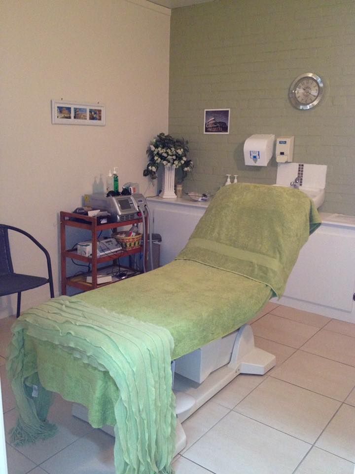A Green Towel Is On A Massage Table In A Room — Xtreme Rejuvenation Clinic, Medispa & Beauty Therapy In Maryborough, QLD