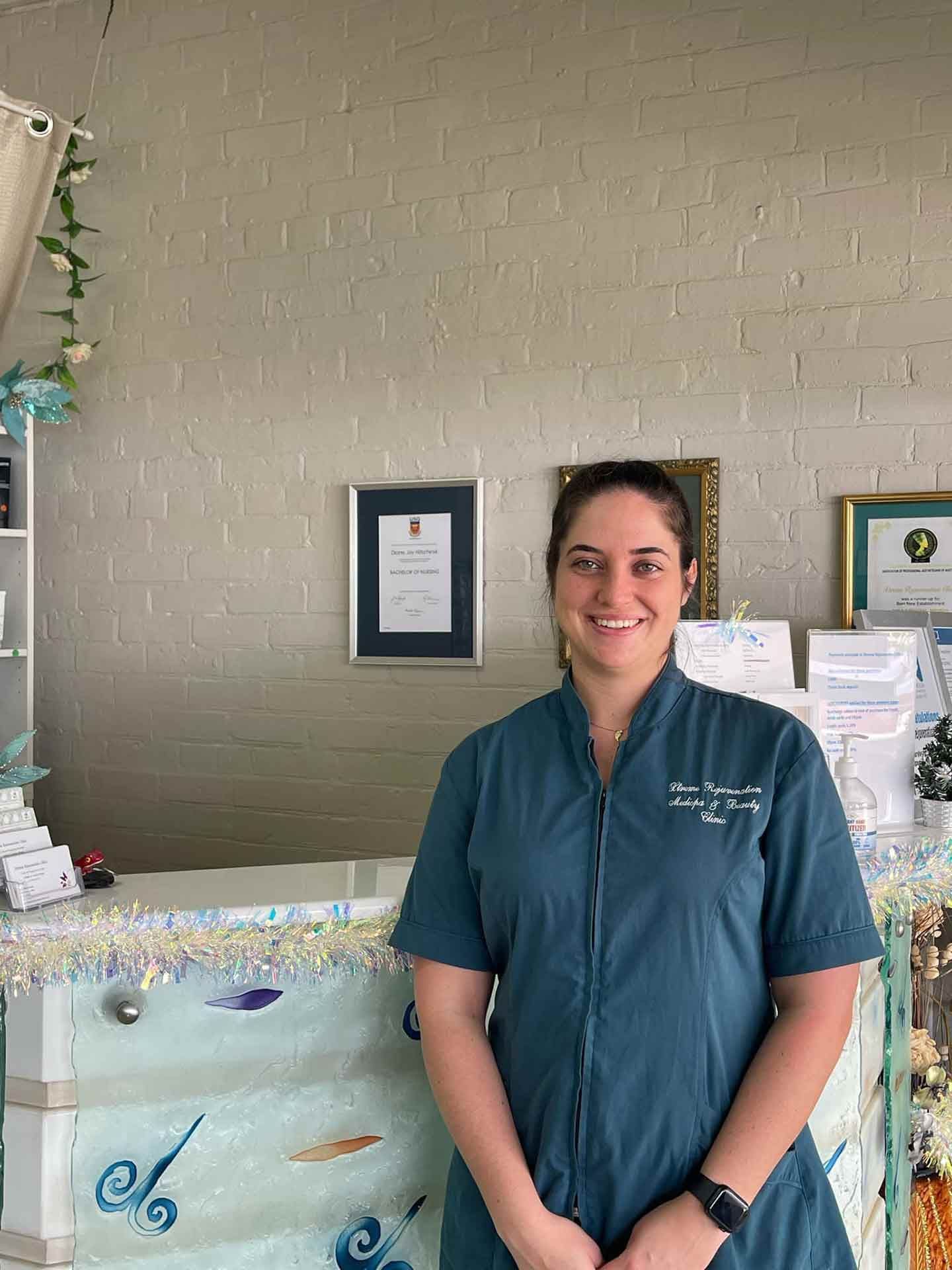 A Woman Is Standing In Front Of A Counter  — Xtreme Rejuvenation Clinic, Medispa & Beauty Therapy In Maryborough, QLD