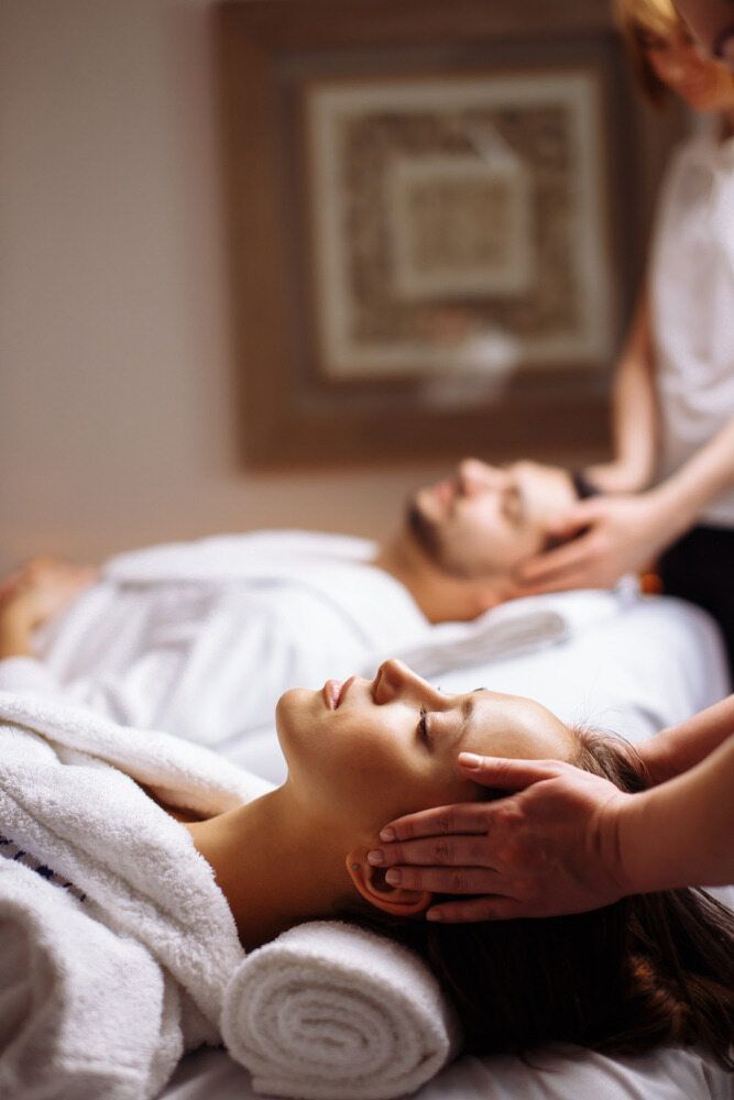 A Man And A Woman Are Getting A Massage In A Spa — Xtreme Rejuvenation Clinic, Medispa & Beauty Therapy In Maryborough, QLD