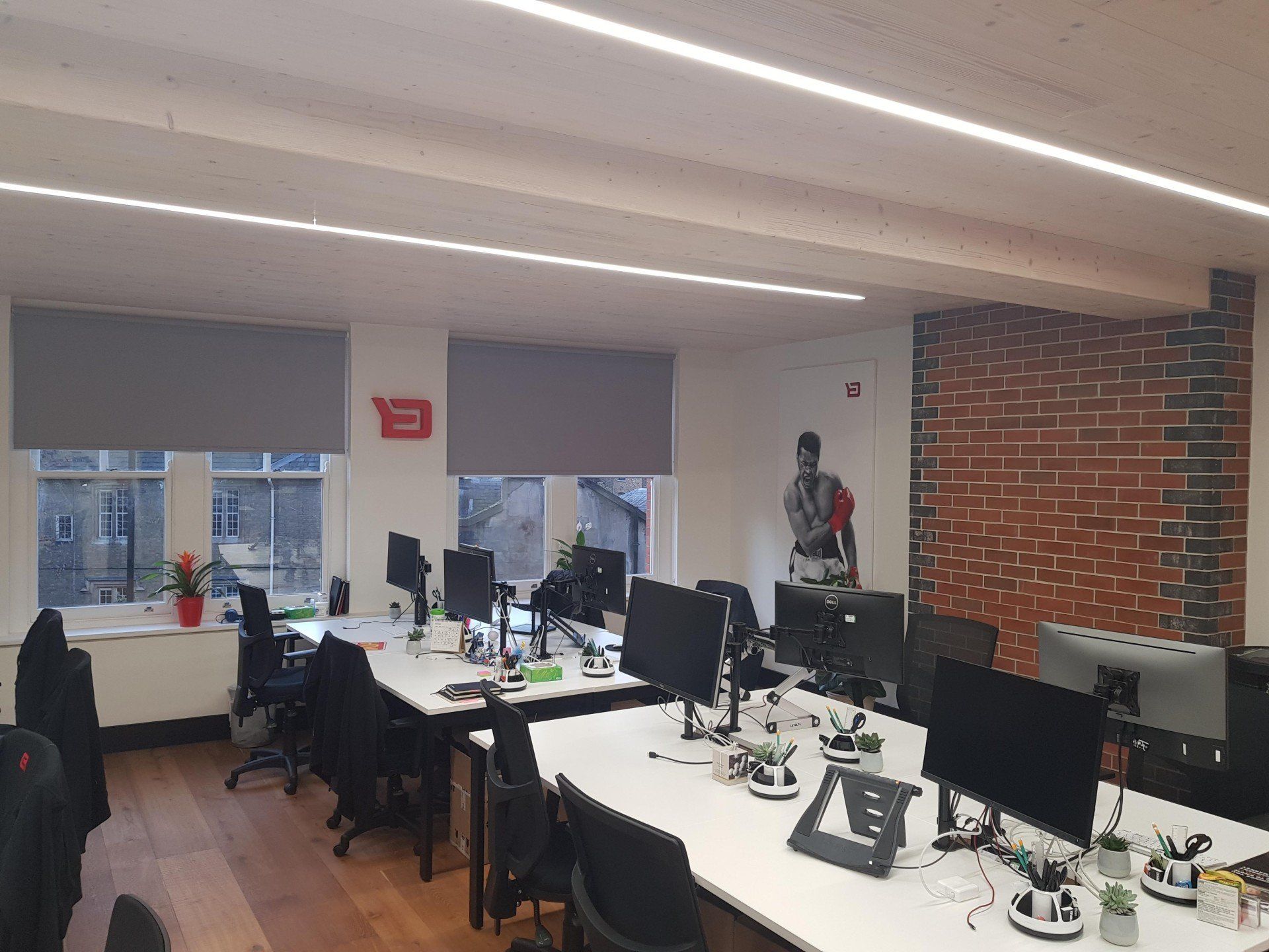 A large office with a lot of desks and computers.