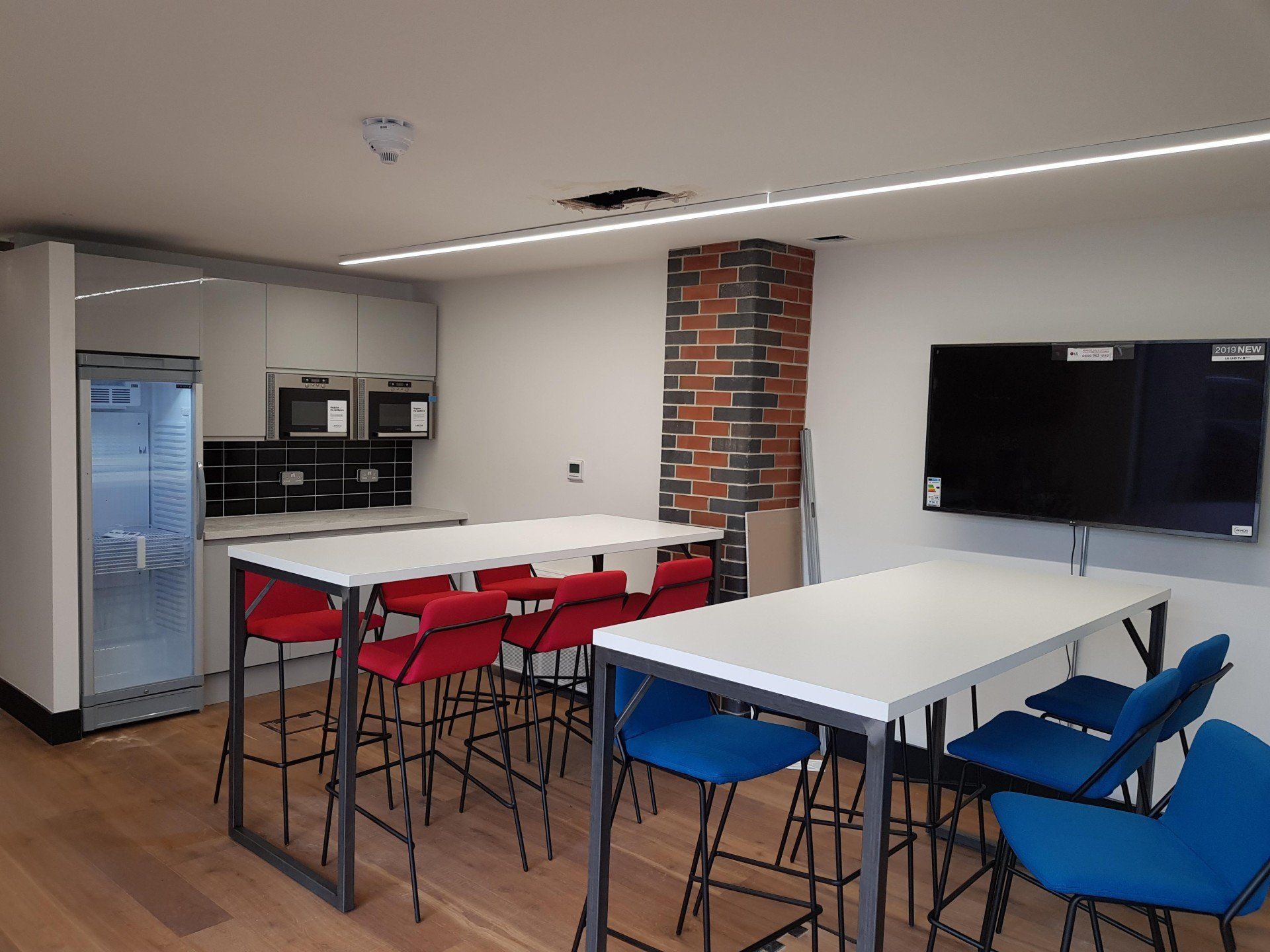 A room with a lot of tables and chairs in it