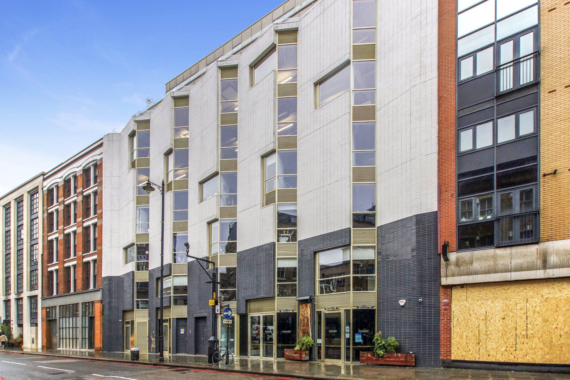 A row of buildings are lined up on a city street.