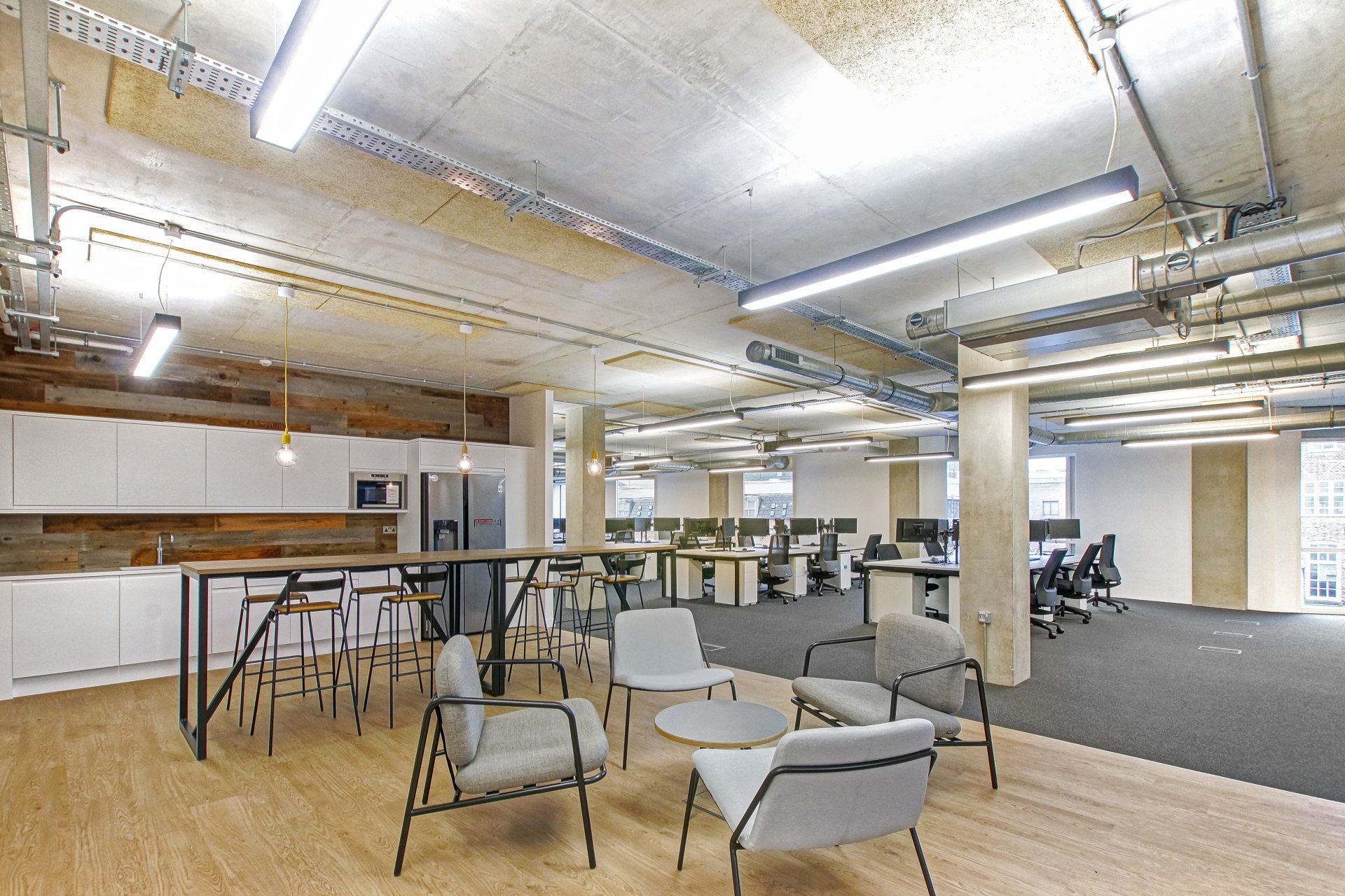 There are many chairs and tables in the room.