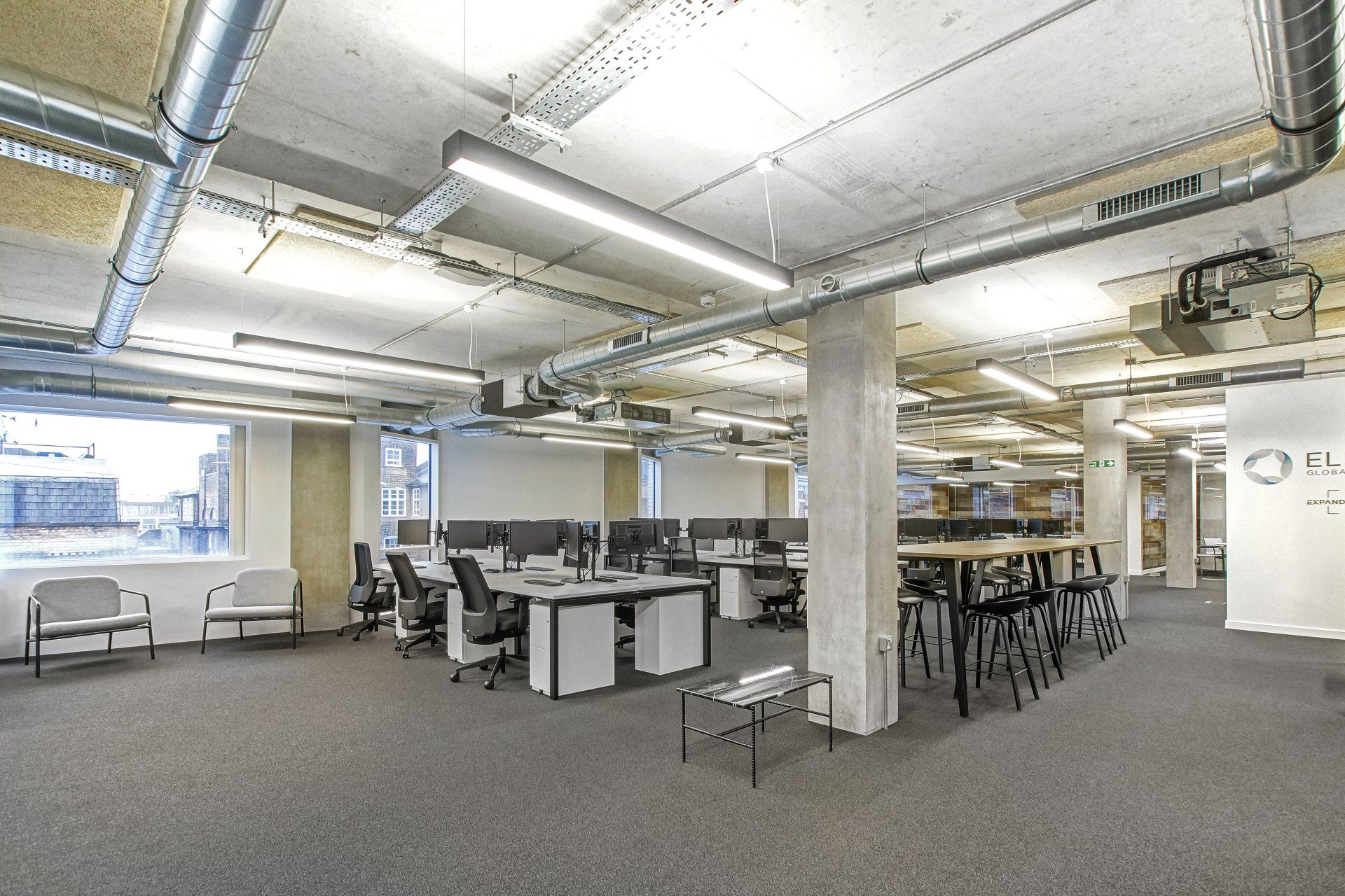 A large office with a lot of desks and chairs.