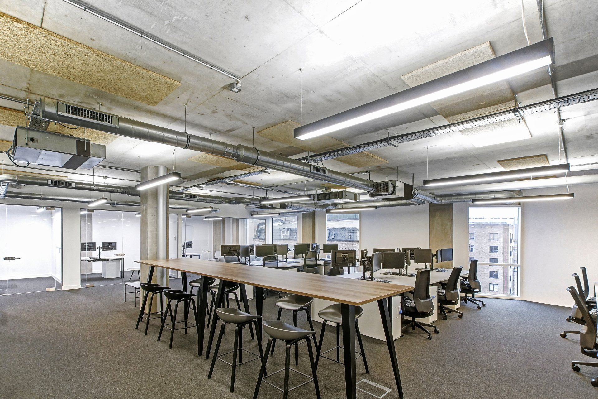 A large room with a long table and chairs in it