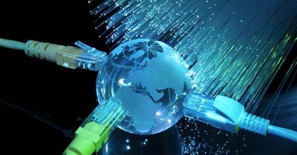 A globe is surrounded by ethernet cables and fiber optics.