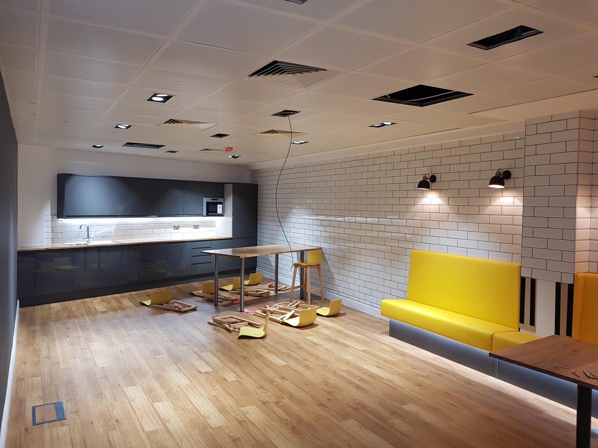 A room with wooden floors and a yellow couch