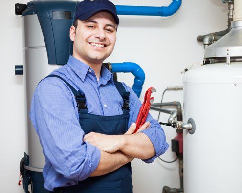 A professional working on a water heater repair in Bettendorf, IA