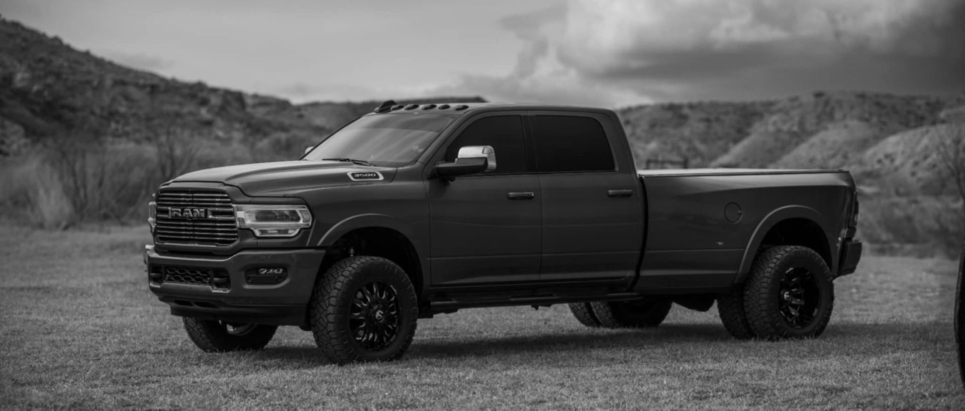 A white ram truck is parked on a white background. | Wind River Auto & Diesel