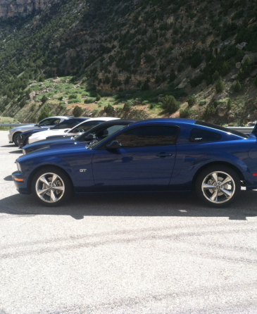 A row of blue cars are parked in a parking lot | Wind River Auto & Diesel