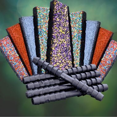 A bunch of sticks with different colored sprinkles on them are stacked on top of each other.