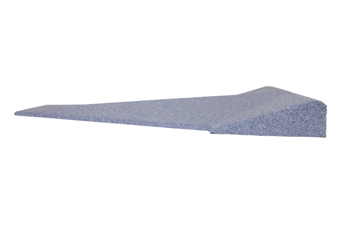 A gray wedge is sitting on a white surface.