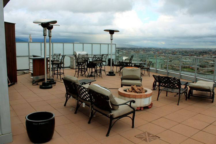 A patio with tables and chairs and a fire pit