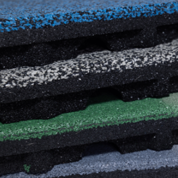 A close up of a stack of rubber mats of different colors.