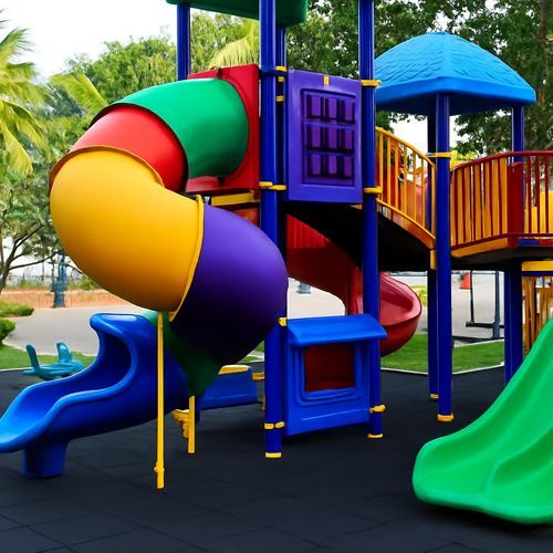 A colorful playground with a slide and a spiral slide