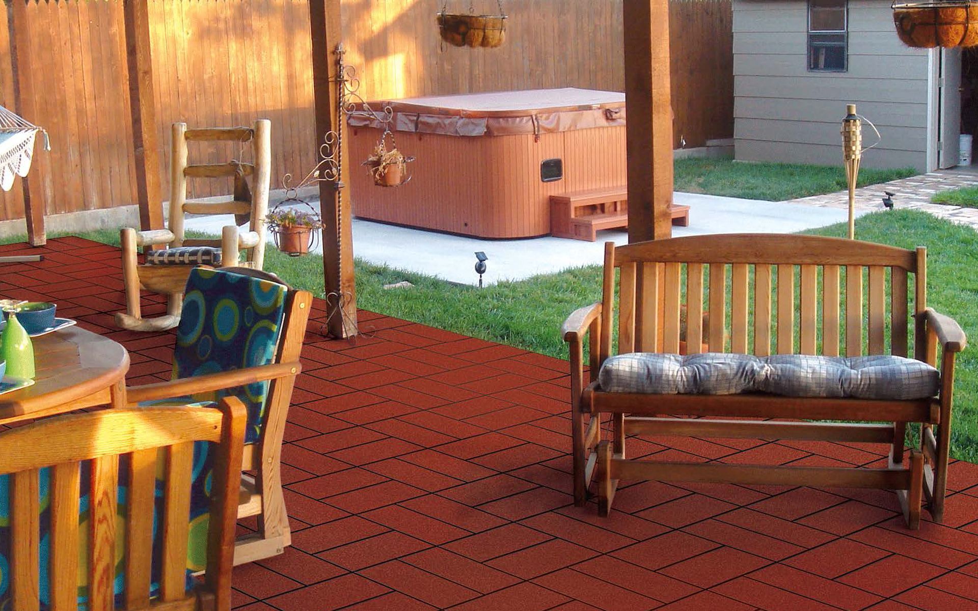 A patio with a bench , table , chairs and a hot tub.