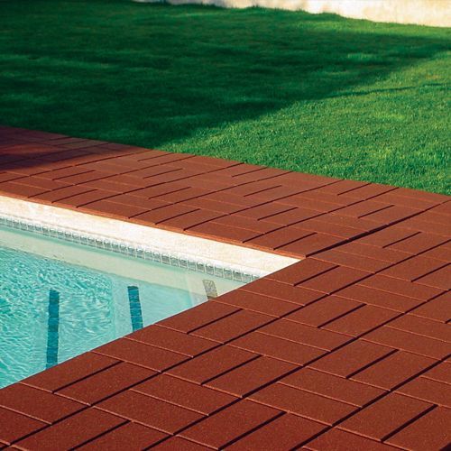 A swimming pool with a wooden deck next to it