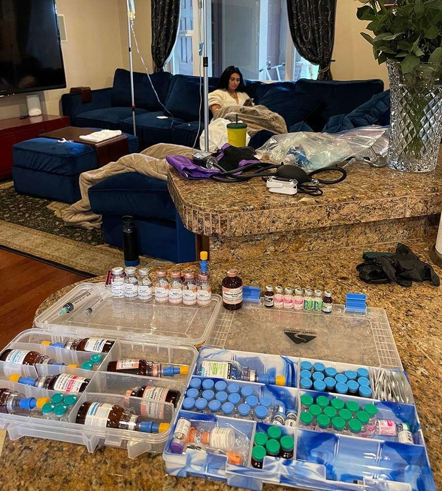 Professional medical vials and supplies used for mobile IV therapy services on a kitchen counter.