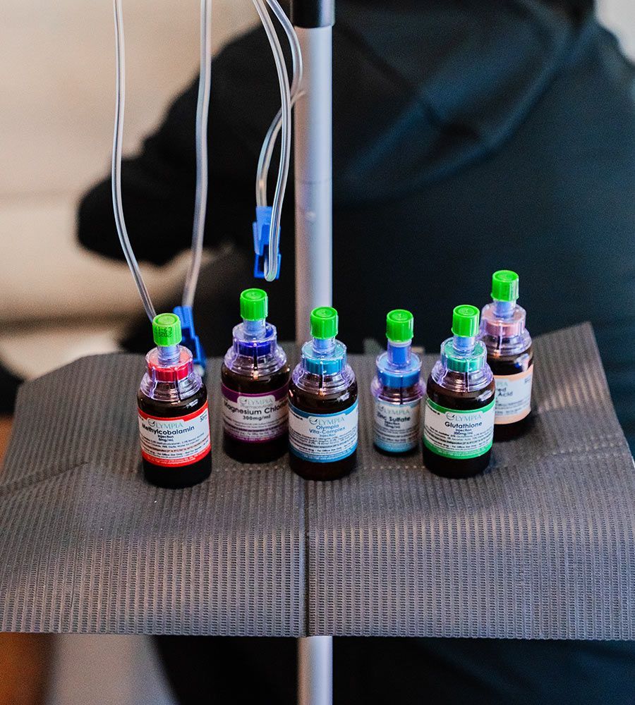 Custom IV infusion preparation, showcasing individual nutrient vials being prepared on a sterile tray for personalized vitamin drips.