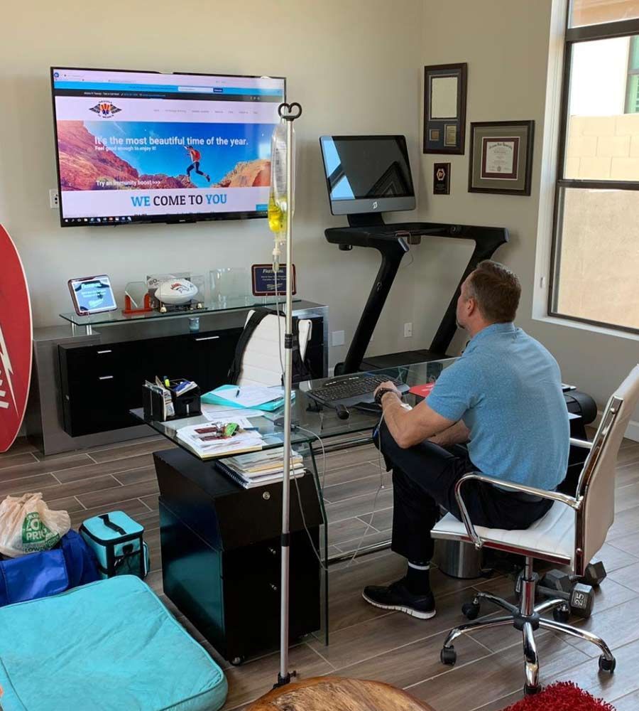 Home office setup with a treadmill and desk, showing convenient IV vitamin infusion service delivered to maximize work efficiency and health.