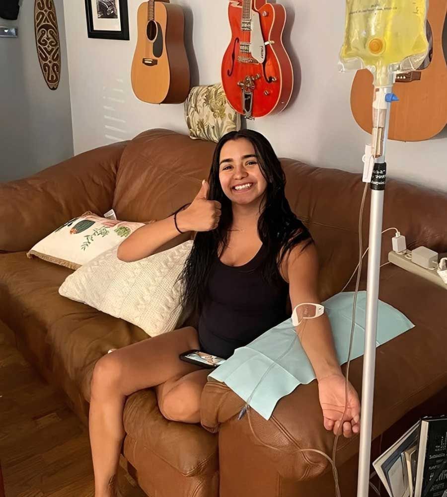 Happy patient receiving at-home IV therapy or infusion service with a positive attitude.