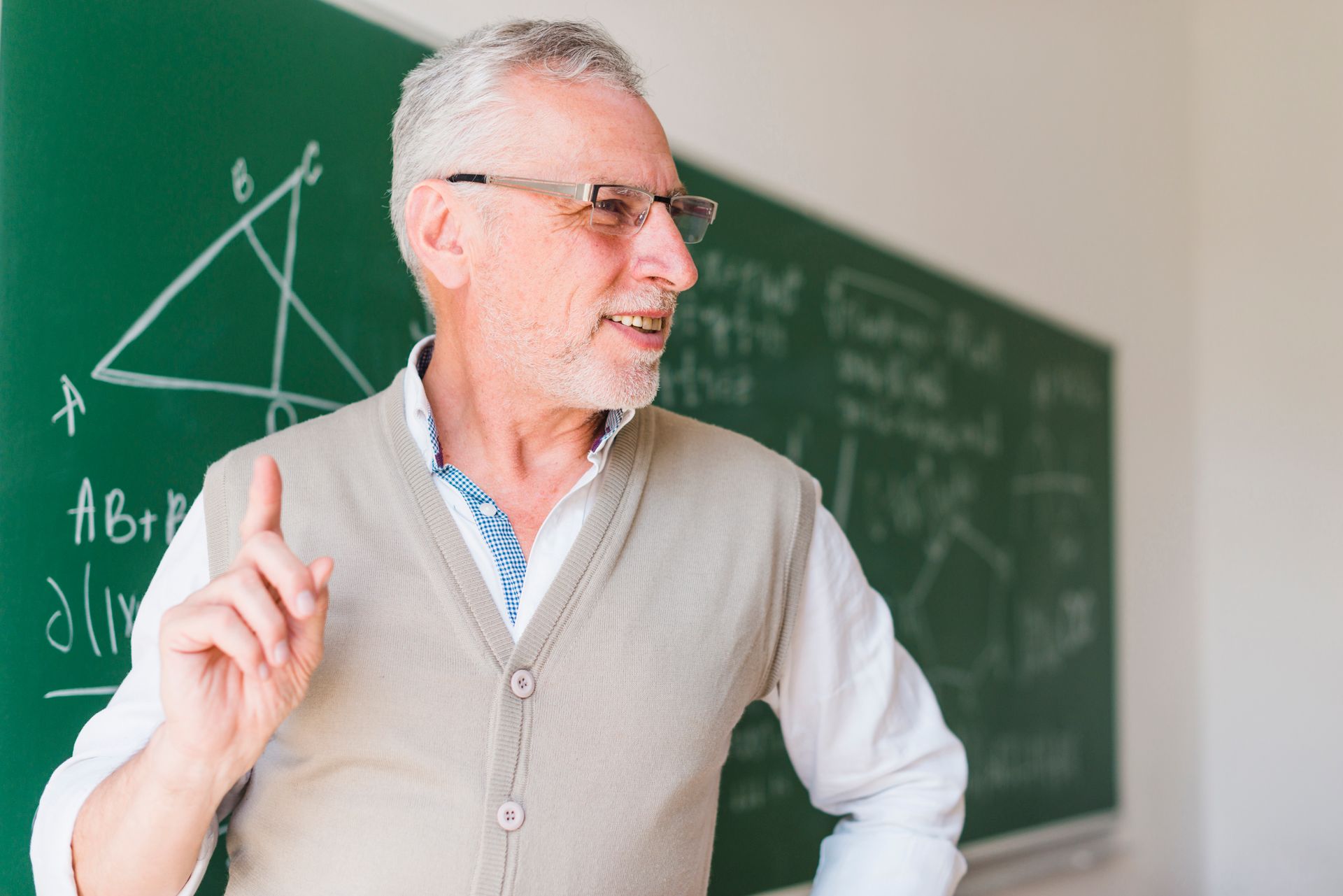 A man is climbing up a rock wall with a rope.