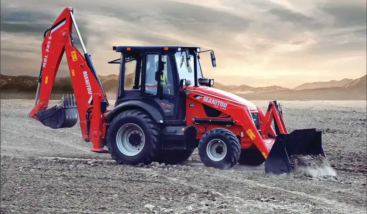 A yellow and black backhoe is sitting on top of a dirt field.