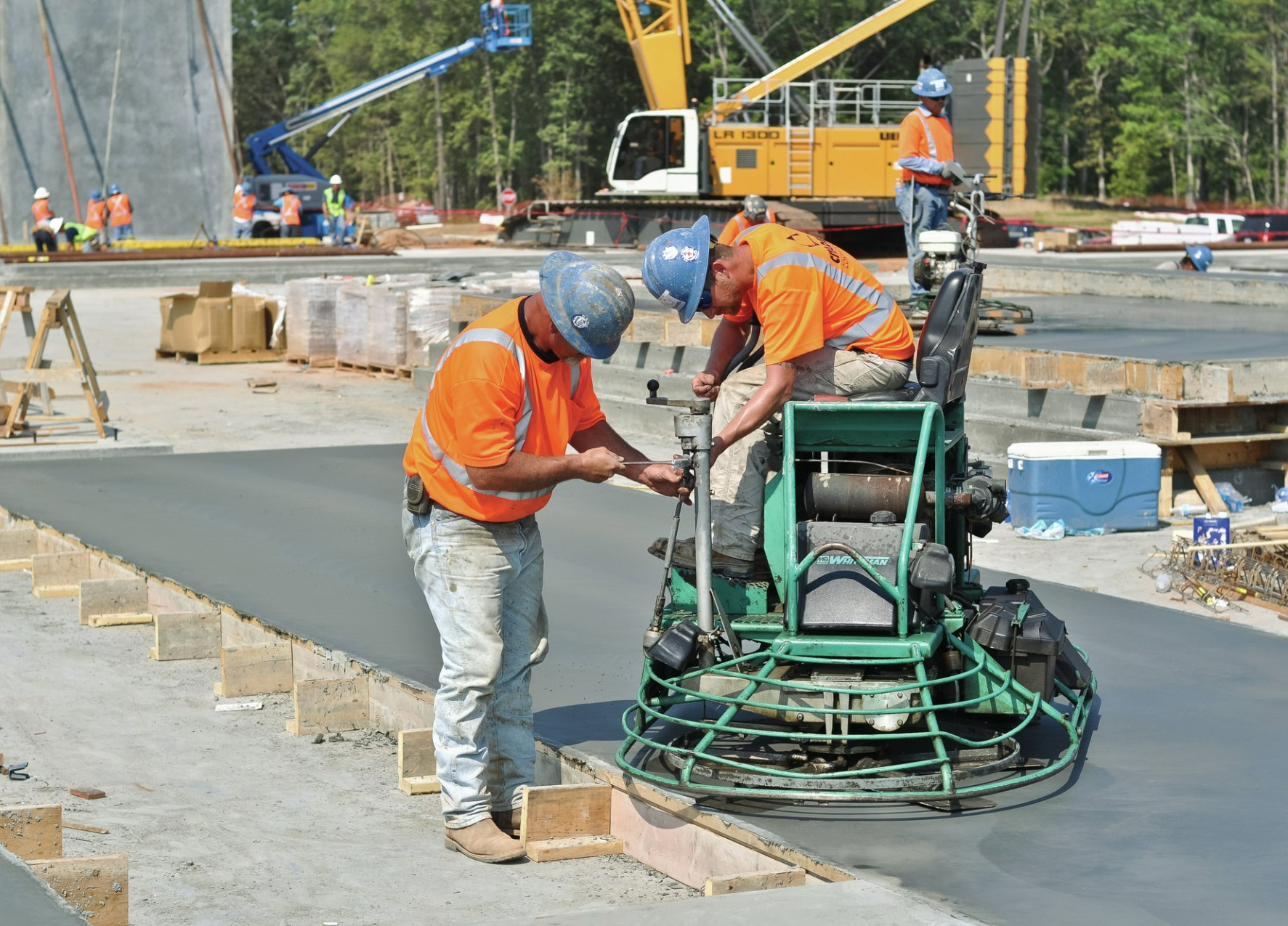 A group of construction workers are working on a road.