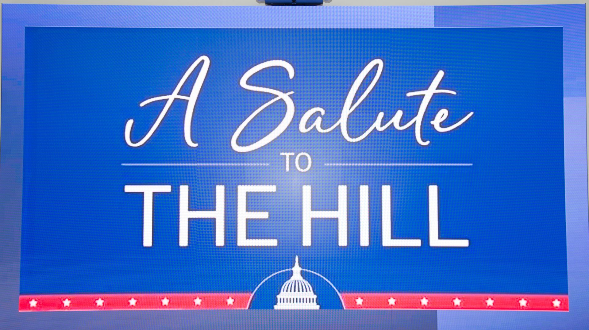 A blue sign that says a salute to the hill