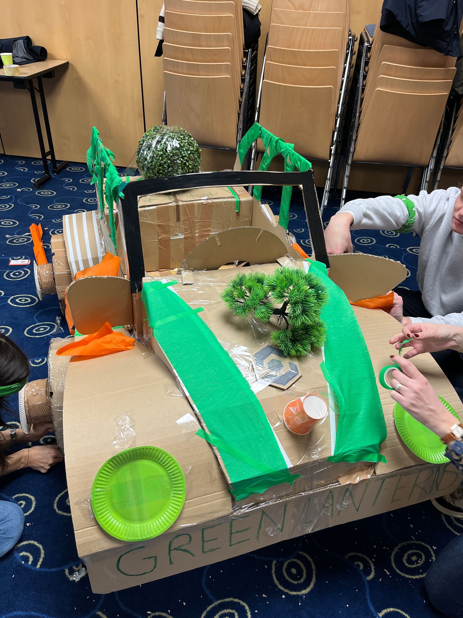 Des personnes tirent au fusil sur un stand de tir extérieur enneigé, avec des cibles au loin et une forêt en arrière-plan.