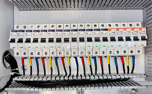 Split image: electrical panel with sparks and family dining under soft light.