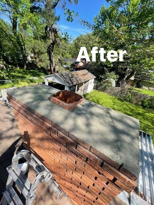 Finished brick chimney with concrete cap, seen from above, with green trees in the background.