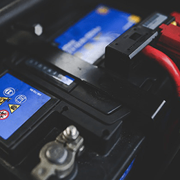 A Close Of a Car Battery with Red Wires Attached to It — In CoolAir Auto Care Salamander Bay NSW, 2317