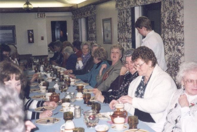 This is a photograph of women sitting at a table eating.