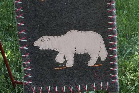 This is a photograph of a quilt with an image of a polar bear on it.